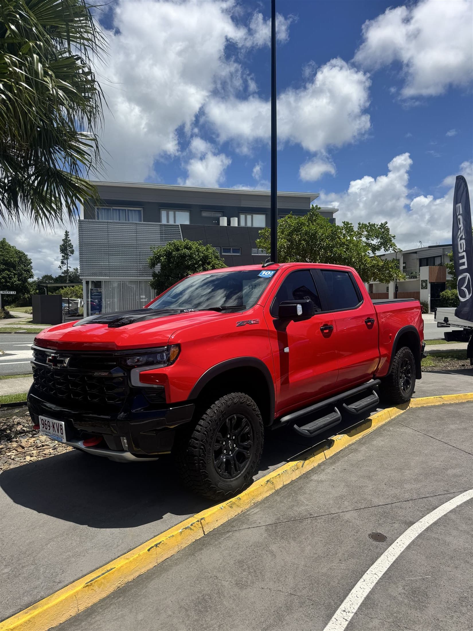 Red ute at the dealership — vehicle dealership context