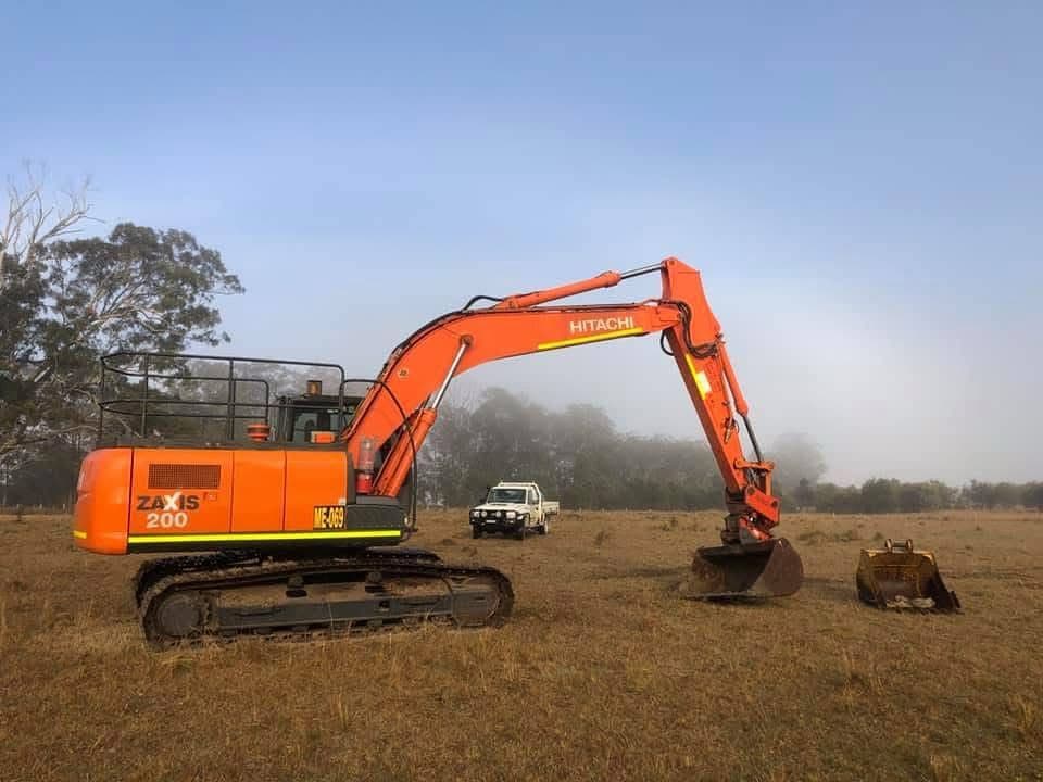Hitachi Zaxis excavator in fog — comparing excavator brands for finance